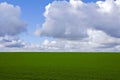 green field blue sky clouds Royalty Free Stock Photo