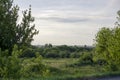 green field and blue sky with light clouds Royalty Free Stock Photo