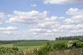 green field and blue sky with light clouds Royalty Free Stock Photo