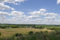 green field and blue sky with light clouds Royalty Free Stock Photo