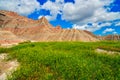 Green field in the foreground with colorful formations at Badlands National Park, South Dakota Royalty Free Stock Photo