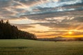 Green Field with Forest at Sunset