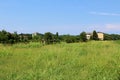 Green field and houses in the distance