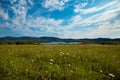 Green field, lake and mountains Royalty Free Stock Photo