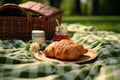 Green field picnic Fabric sheet, basket, croissants, and jam