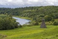 Green field with river under blue sky Royalty Free Stock Photo