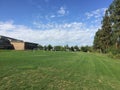 Green field in school yard with soccer and basketball nets