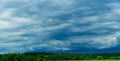 Green field with skyline and dark stormy sky Royalty Free Stock Photo