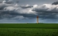 Green field, stormy sky, water tower Royalty Free Stock Photo
