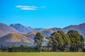Green field and trees in front of Mount Hutt mountain range, Methven, New Zealand Royalty Free Stock Photo