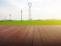 Synthesis of textured wooden planks floor and green field background. Royalty Free Stock Photo