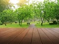 Synthesis of textured wooden planks floor and green field background.