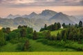 Green field and view of Trzy Korony, Pieniny Mountains Peak in Poland at Spring. Royalty Free Stock Photo