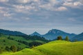 Green field and view of Trzy Korony, Pieniny Mountains Peak in Poland at Spring. Royalty Free Stock Photo