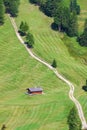 Green field and wooden house on the mountains Royalty Free Stock Photo