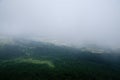 Fields among the fog in a valley whit forest