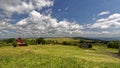 Green fields and grassland around a wooden structure