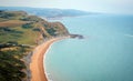 Green fields on a hill with the sea English Channel and English countryside in the background. Golden Cap on jurassic coast in Royalty Free Stock Photo