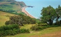 Green fields on a hill with the sea English Channel and English countryside in the background. Golden Cap on jurassic coast in Royalty Free Stock Photo