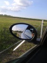 Green fields and rearmirror of car Royalty Free Stock Photo