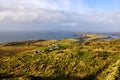 Green fields and small village on the coast, coastline and islands in a distance, Wiled Atlantic Way