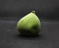 Green fig on grey background.