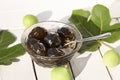 Green fig jam bowl on white wooden table Royalty Free Stock Photo