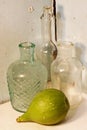 GREEN FIG ON A SHELF WITH ANTIQUE BOTTLES Royalty Free Stock Photo