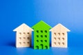 Green figure of a residential building stands out among the rest of the houses. Search for the best option to buy an apartment Royalty Free Stock Photo