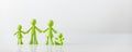 Green figures made of biodegradable plastic model of family with children