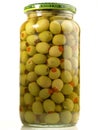 Green filled Olives in a Glass on white Background - Isolated