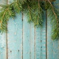 Green fir branches with on a wooden brown texture.