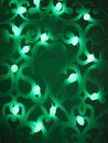 Green fir cones Christmas lights garland on dark background. Christmas or new year led lights garland. Blurred green glowing light Royalty Free Stock Photo