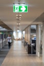 Green fire escape sign hang on the ceiling in the office. Royalty Free Stock Photo