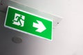 Green fire exit sign in the building. Royalty Free Stock Photo
