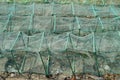 Rows of green net fish traps on a beach in Southeast Asia Royalty Free Stock Photo