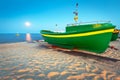 Green fishing boat on the beach of Baltic sea