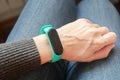 Green fitness tracker on a girls hand. Fitness bracelet for sports training.