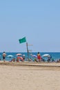 Green flag installed on top of lifeguard seat on Patacona beach in Valencia