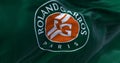 Green flag with Roland Garros logo waving in the wind