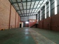 Green floored vacant industrial warehouse space to let