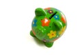 Green Flowery piggy bank with money Royalty Free Stock Photo