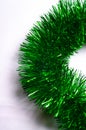 Green fluffy macro rain garland to decorate the Christmas tree on a merry Christmas