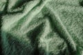Green fluffy soft textile background with drapers. Top view. Copy space. fashion, style, elegance concept