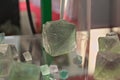 Green Fluorite Natural Octahedron Crystals on glass table