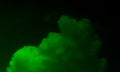 Green fog or smoke special effect. Green cloudiness, mist or smog on black background.