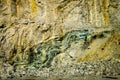 Green folded rock formation inside mountain wall Royalty Free Stock Photo