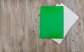 Green folder for documents and a white envelope. Wood background. Copy of space. Place for text.