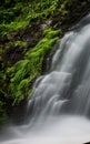 Green foliage edges soft waterfall in NC mountains