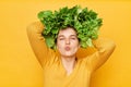 Green food lifestyle. Slimming weight loss. Care for wellness. Romantic woman with lettuce hair style with green vegetables on her